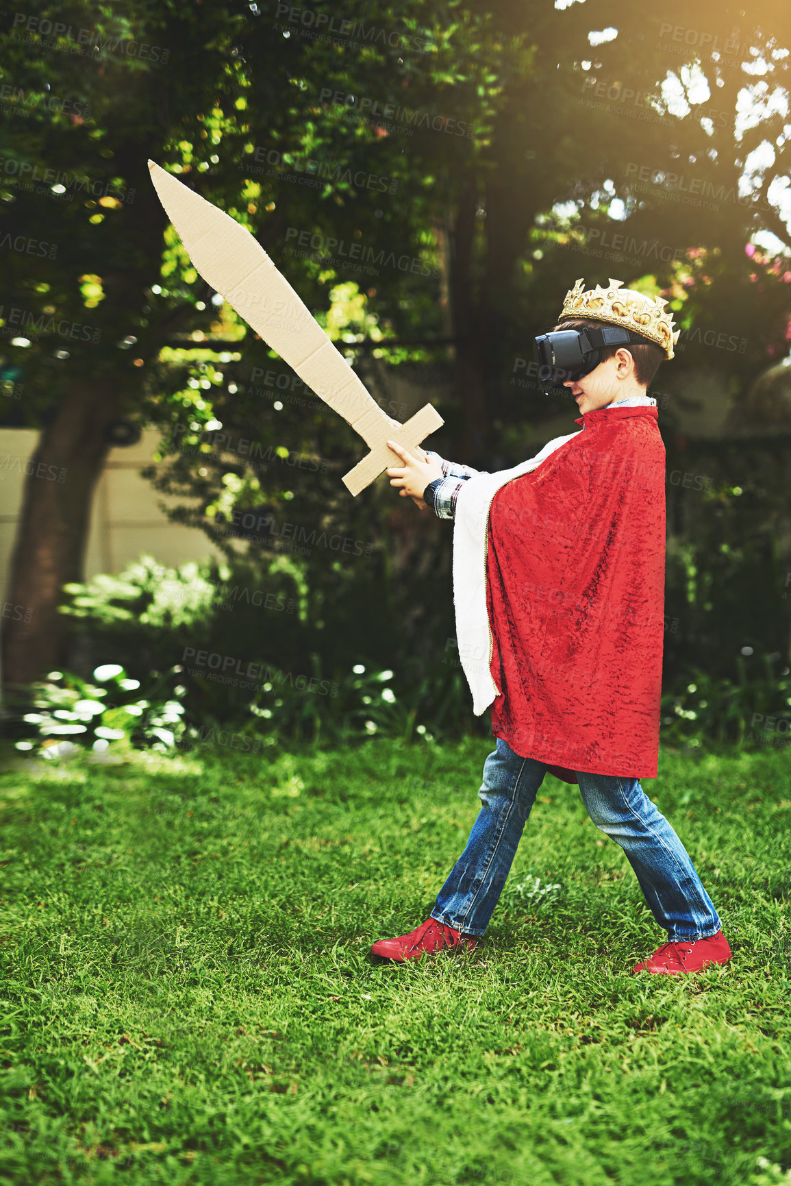 Buy stock photo Kid, costume and vr for fun, play and cyber fantasy with cardboard sword in garden. King, crown and boy with smile, home and dress up adventure with virtual reality entertainment with headset