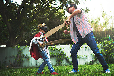 Buy stock photo Father, son and playing with sword for fight, VR or bonding in costume cosplay or backyard at home. Fun dad, child or little boy enjoying outdoor game on grass field, lawn or virtual reality at house