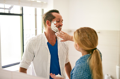 Buy stock photo Cropped shot of a little girl applying shaving cream to her father's face at home