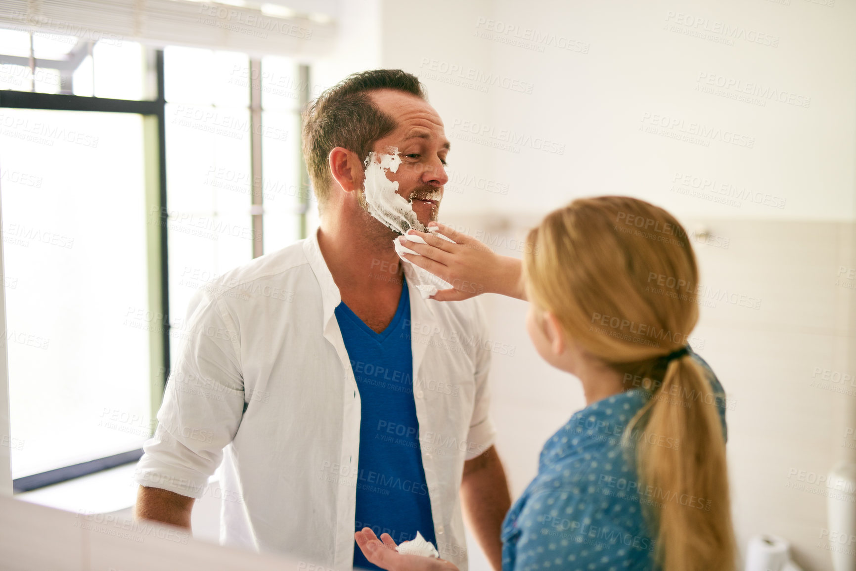 Buy stock photo Cropped shot of a little girl applying shaving cream to her father's face at home