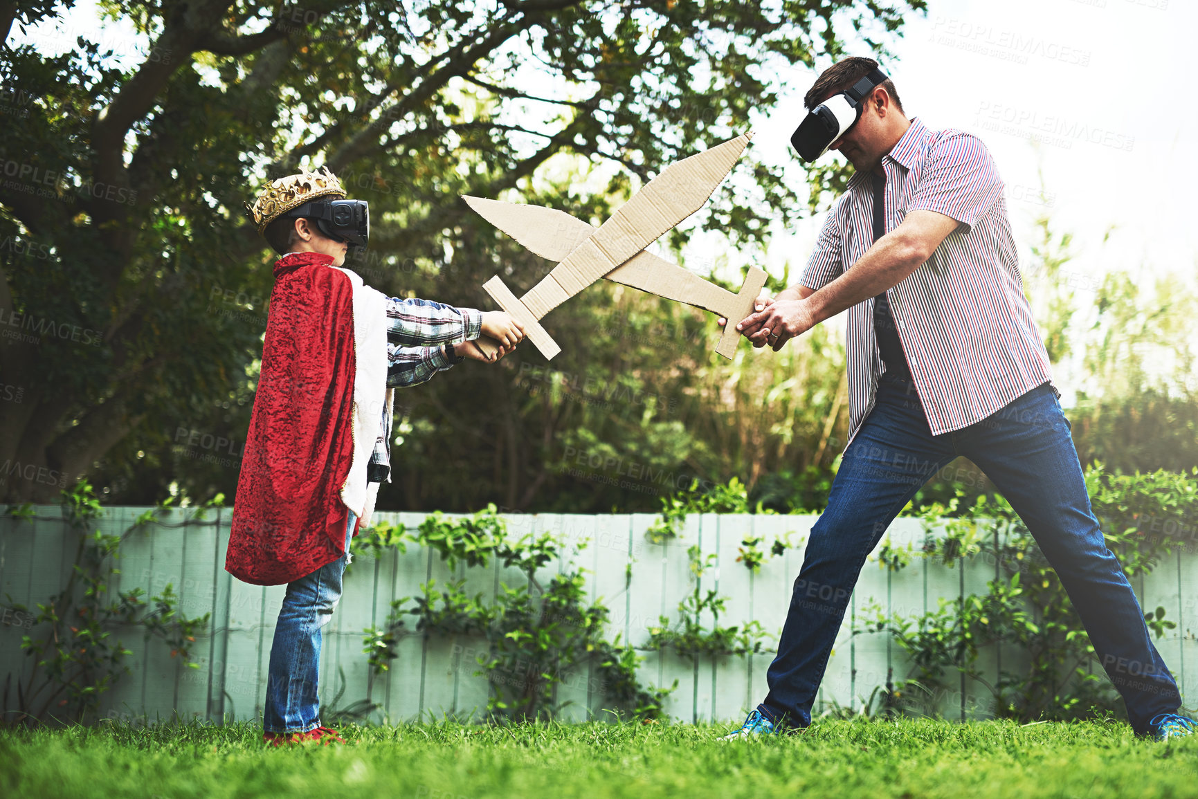 Buy stock photo Father, son and playing with sword fight for bonding or VR in costume, cosplay or backyard at home. Fun dad, child or little boy enjoying outdoor game on grass field, lawn or virtual reality at house