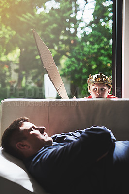 Buy stock photo Fantasy, sleeping and sneaky boy with father on sofa in living room of home for fun, game or leisure. Crown, playing or sword with single parent man and kid in apartment for child development