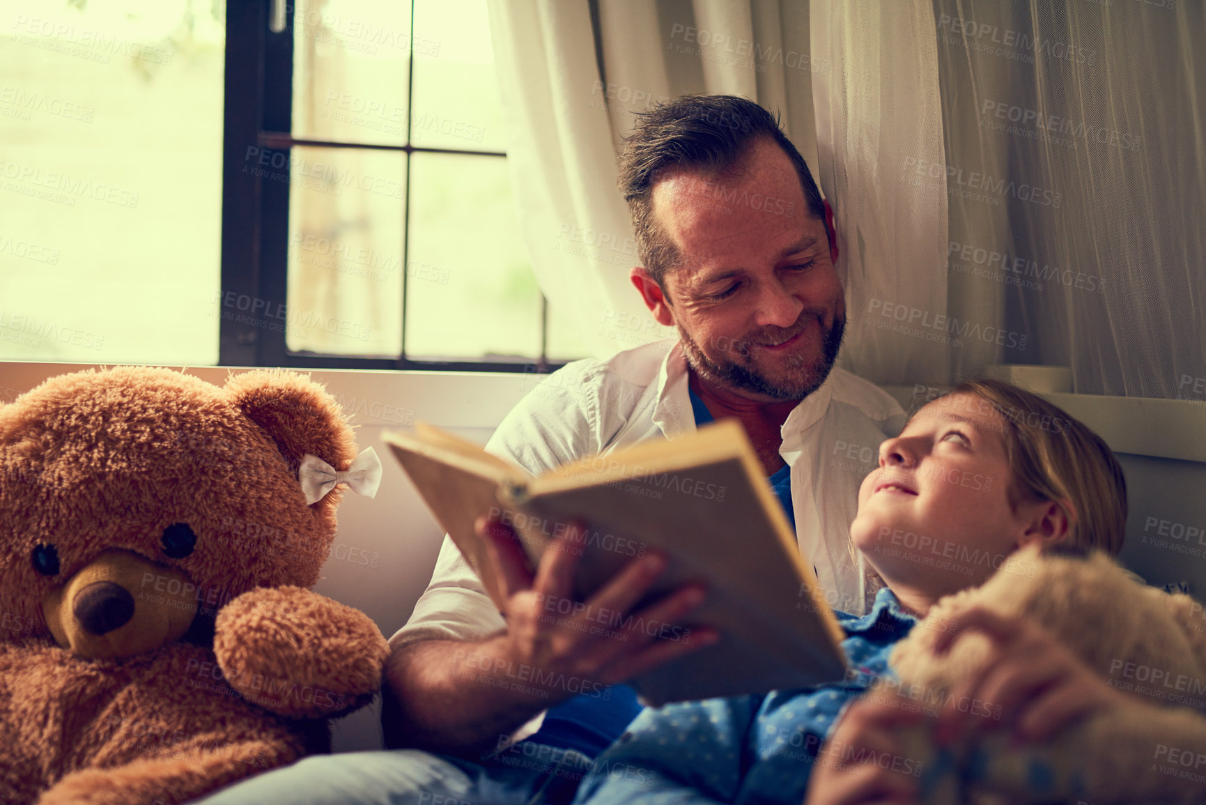 Buy stock photo Home, girl and dad with book for reading story, bonding together and connection with fantasy. Bed, father and daughter to listen to storytelling, education and curious kid for cognitive development