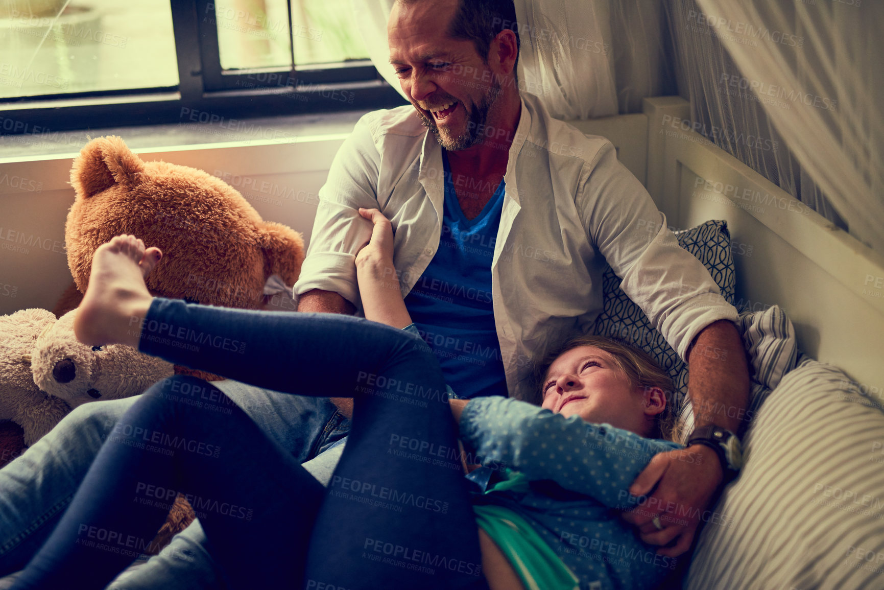 Buy stock photo Bed, laughing and father tickling daughter in home together for bonding, fun or morning game. Family, funny or smile with happy single parent man and girl child in bedroom of apartment for love