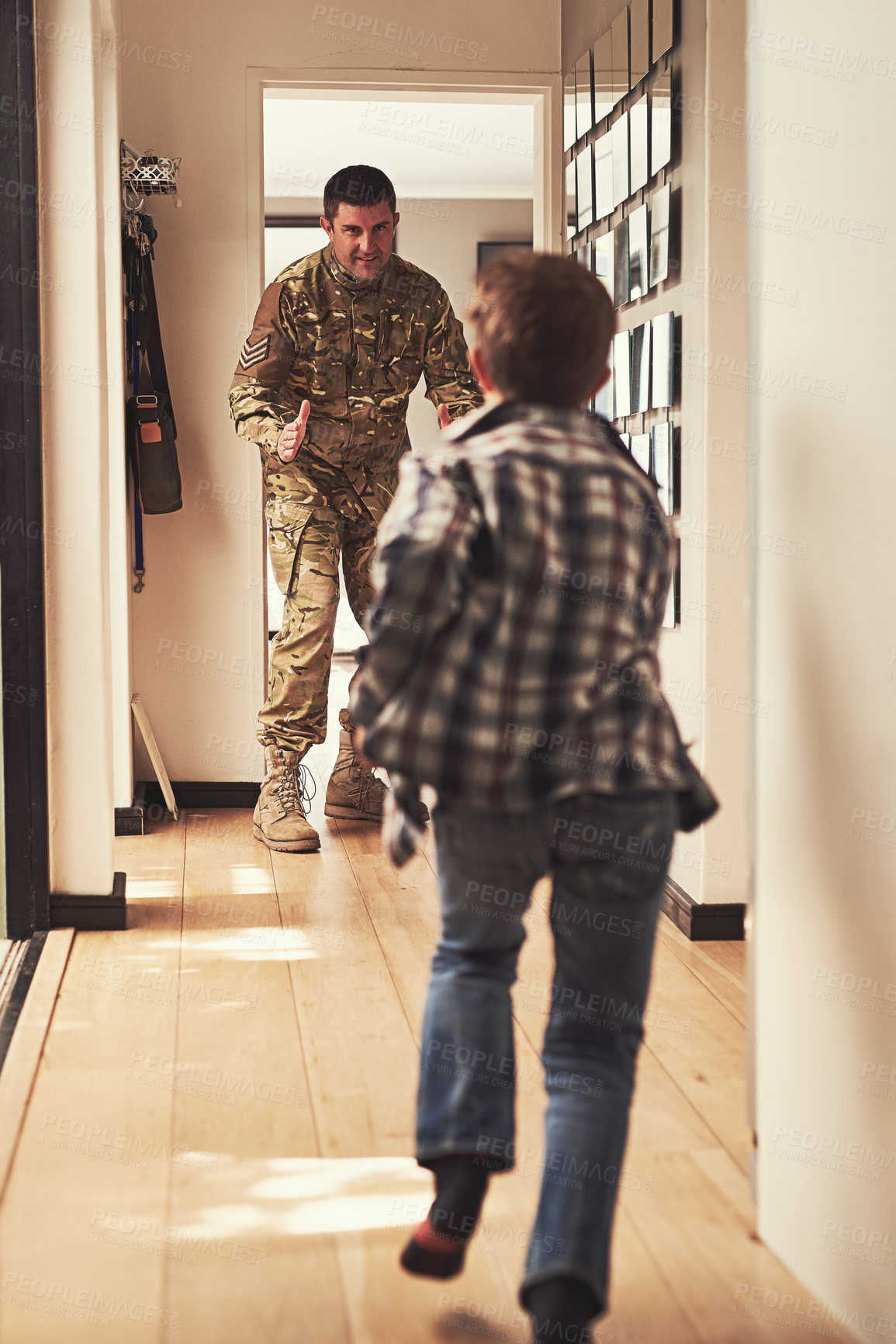 Buy stock photo Father, soldier and child running in hallway for welcome home, hello and excited for family. Military man or love, son and greeting or hug at front door with happiness, hero and return from army 