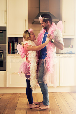 Buy stock photo Shot of a father and his little daughter dancing together at home