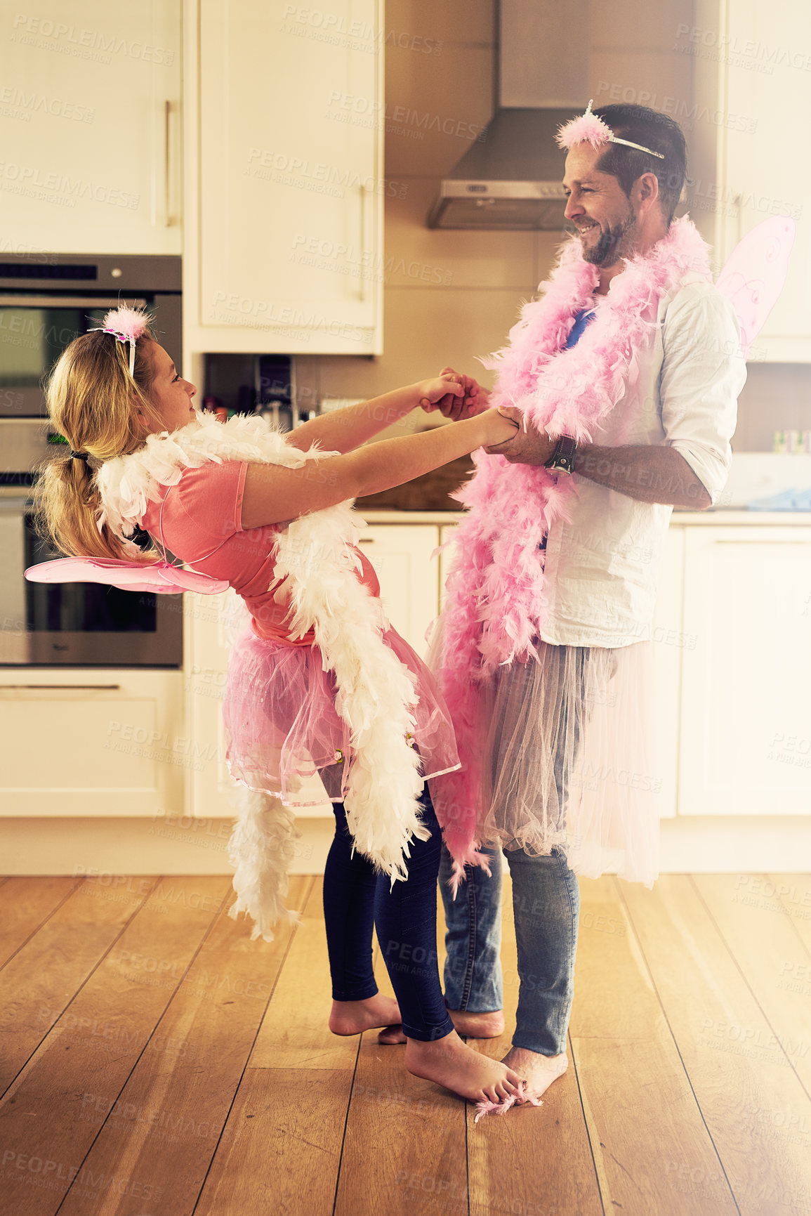 Buy stock photo Dancing, playing or father with princess or girl on toes in home with pink costume, smile or parent. Happy family, holding hands or man with child fairy for dress up, love or games with kid or music