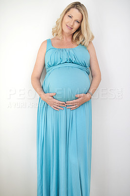 Buy stock photo Portrait of a pregnant woman posing against a white background