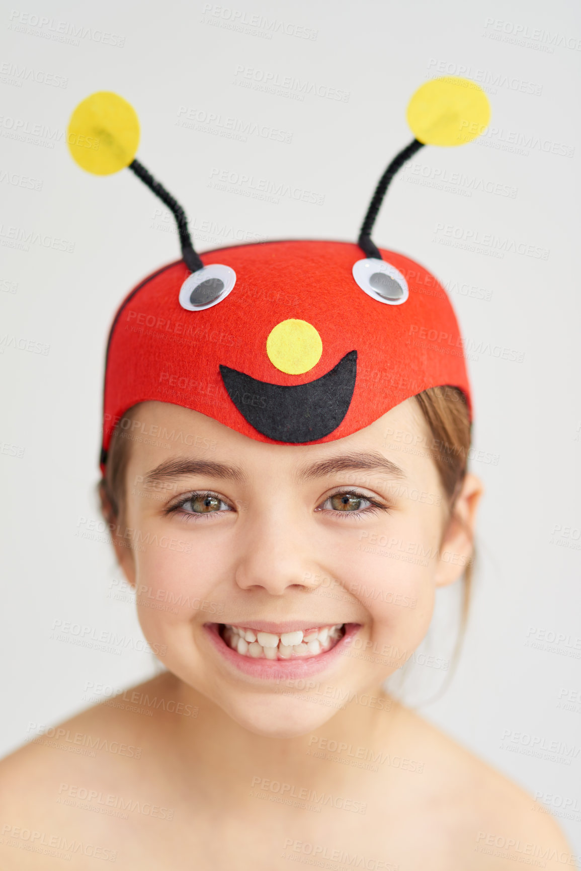 Buy stock photo Studio portrait of a cute little girl wearing a funny hat