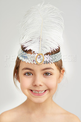 Buy stock photo Studio portrait of a cute little girl wearing a sparkly feathered headband