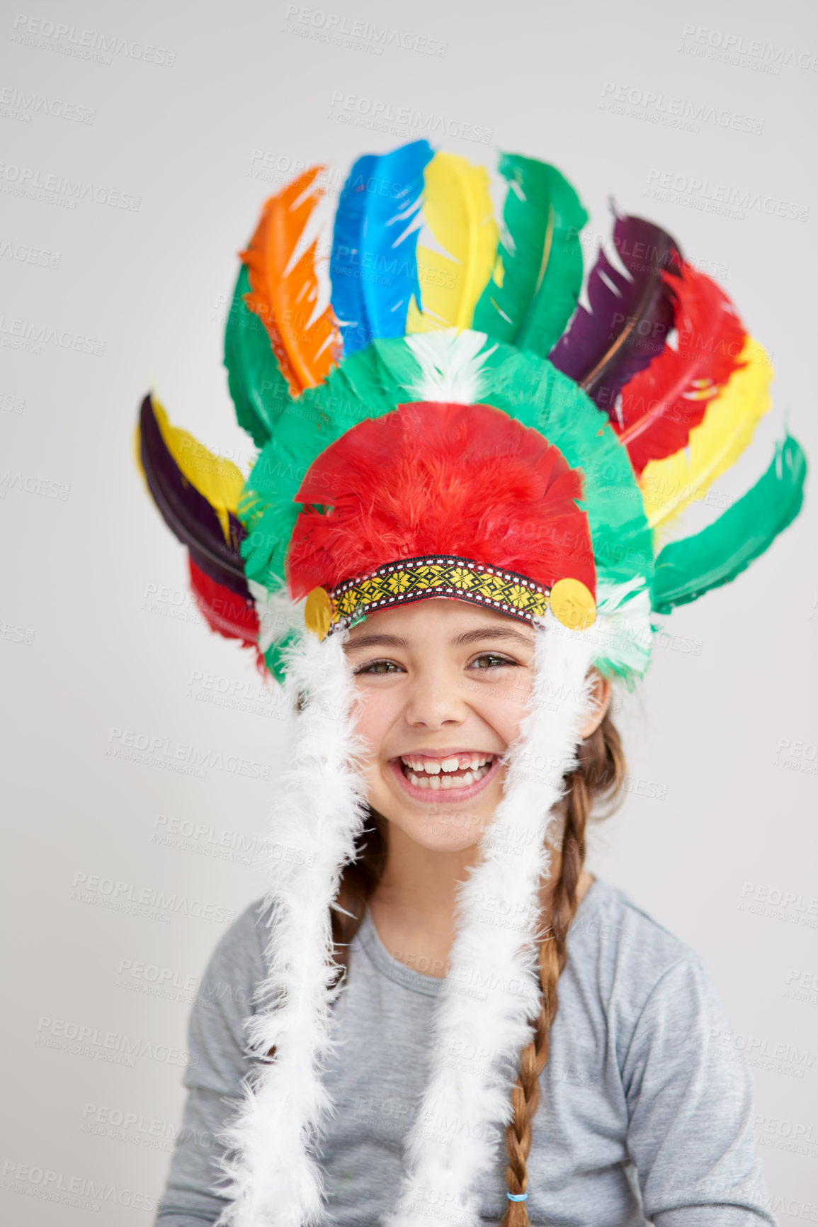 Buy stock photo Portrait, kid and girl with feather hat, smile and happiness with culture, traditional accessory and costume. Face, youth and child with Halloween dress up and laughing on white studio background