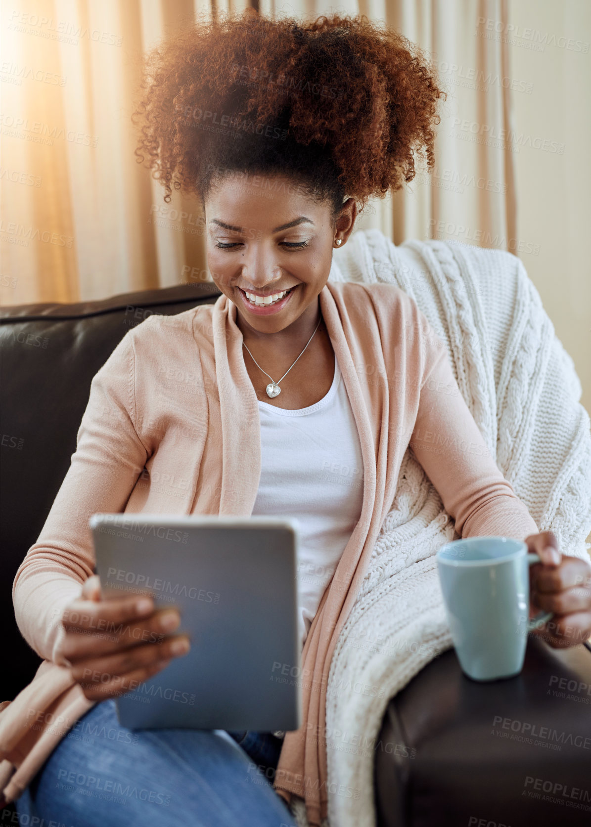 Buy stock photo Home, coffee and black woman with tablet, relax or connection with lens flare, internet or digital app. African person, apartment or happy girl on couch, tech or smile with tea, latte or social media