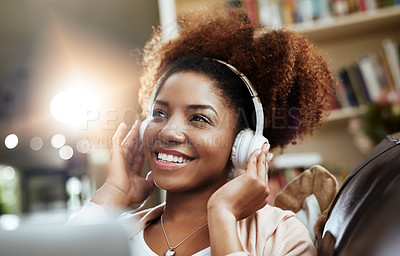 Buy stock photo Happy, laptop and black woman on couch with headphones, smile and morning streaming in living room. Relax, wellness and girl on sofa in home with online music, digital app and computer in apartment.