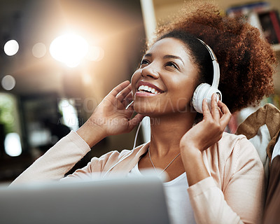 Buy stock photo Thinking, laptop and woman on sofa with headphones, smile and morning streaming in living room. Relax, wellness and girl on couch in home with online music, digital app and computer in apartment.