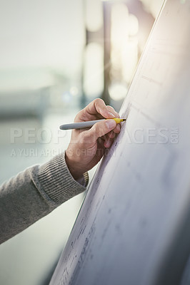 Buy stock photo Closeup shot of an unidentifiable businessman writing on a whiteboard in an office