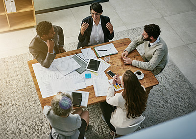 Buy stock photo High angle shot of a group of businesspeople having a meeting in an office