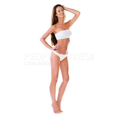 Buy stock photo Studio portrait of a beautiful young brunette woman in a white bikini with her hand in her hair isolated on white