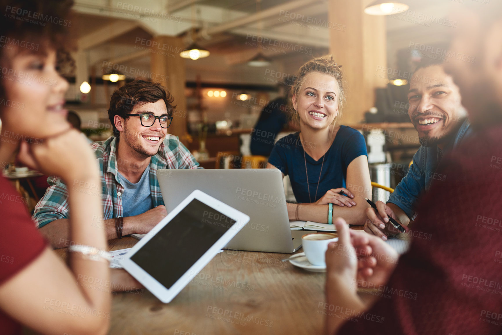 Buy stock photo Shot of students studying in a coffee shop