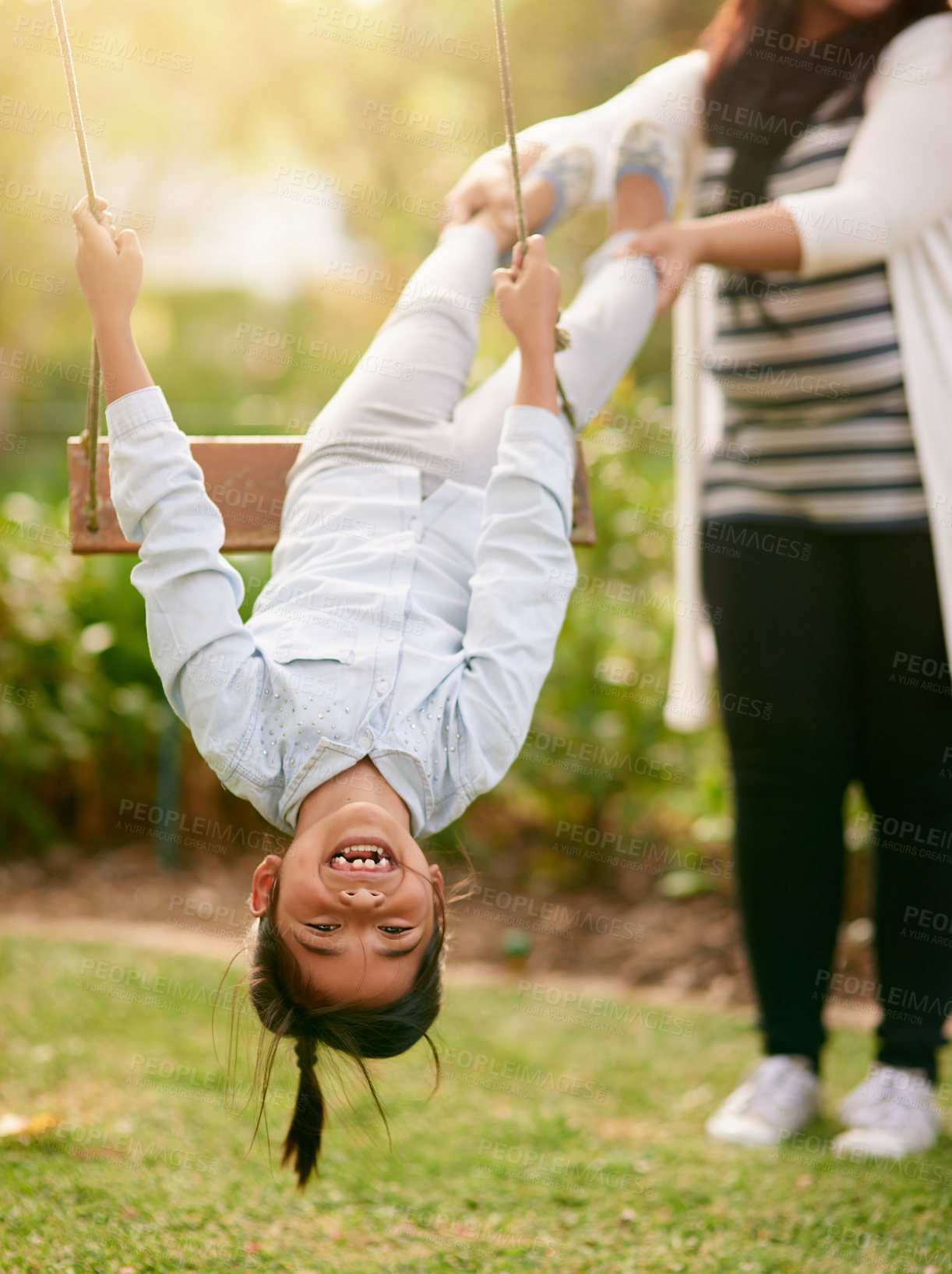 Buy stock photo Happy, girl and mother with swing in park for playing, bonding and having fun together outdoors. Nature, weekend and mom pull daughter in playground for relaxing, childhood and happiness in summer