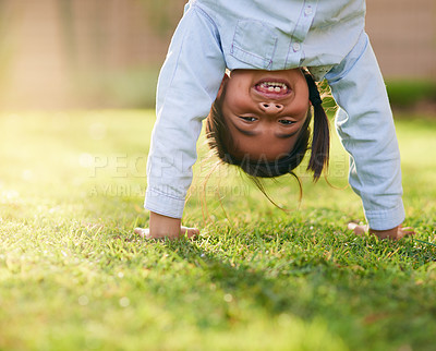 Buy stock photo Happy, girl and handstand with grass in park for playing, sunshine and having fun outdoors. Nature, weekend and portrait with smile in playground for relaxing, childhood and upside down in summer