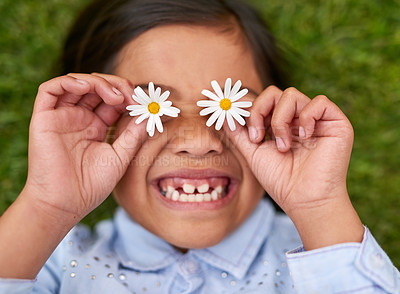 Buy stock photo Girl, child and flower on eyes with happy on grass for playful fun, nature and calm vacation with enjoy freedom. Smile, kid and relax, care and plant for glasses, field and sustainable in summer