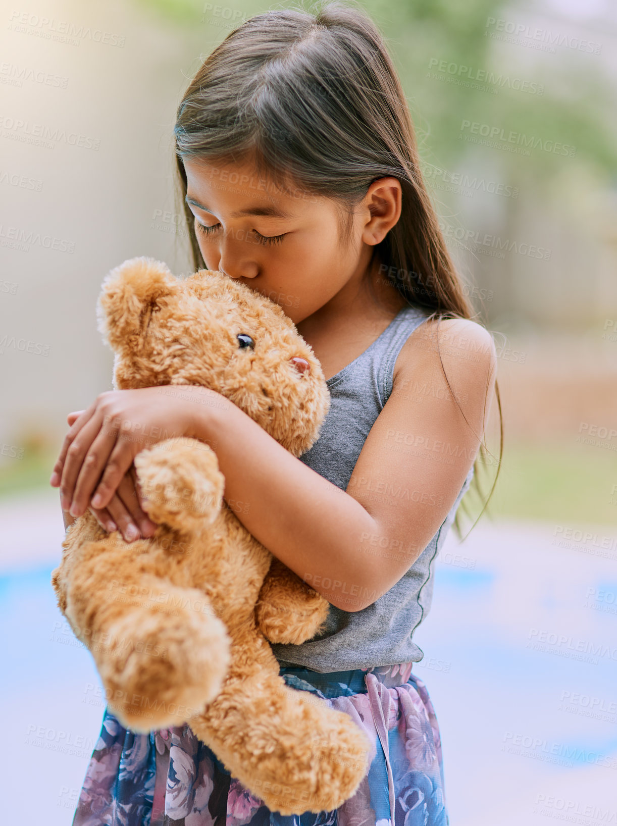 Buy stock photo Cropped shot of a little girl kissing her teddy bear