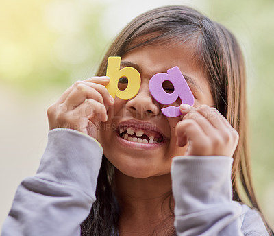 Buy stock photo Girl, alphabet and playful in learning to read as scholar in home schooling with letters for fun. Happy child, student and education in elementary with smile for development, growth and colorful abc