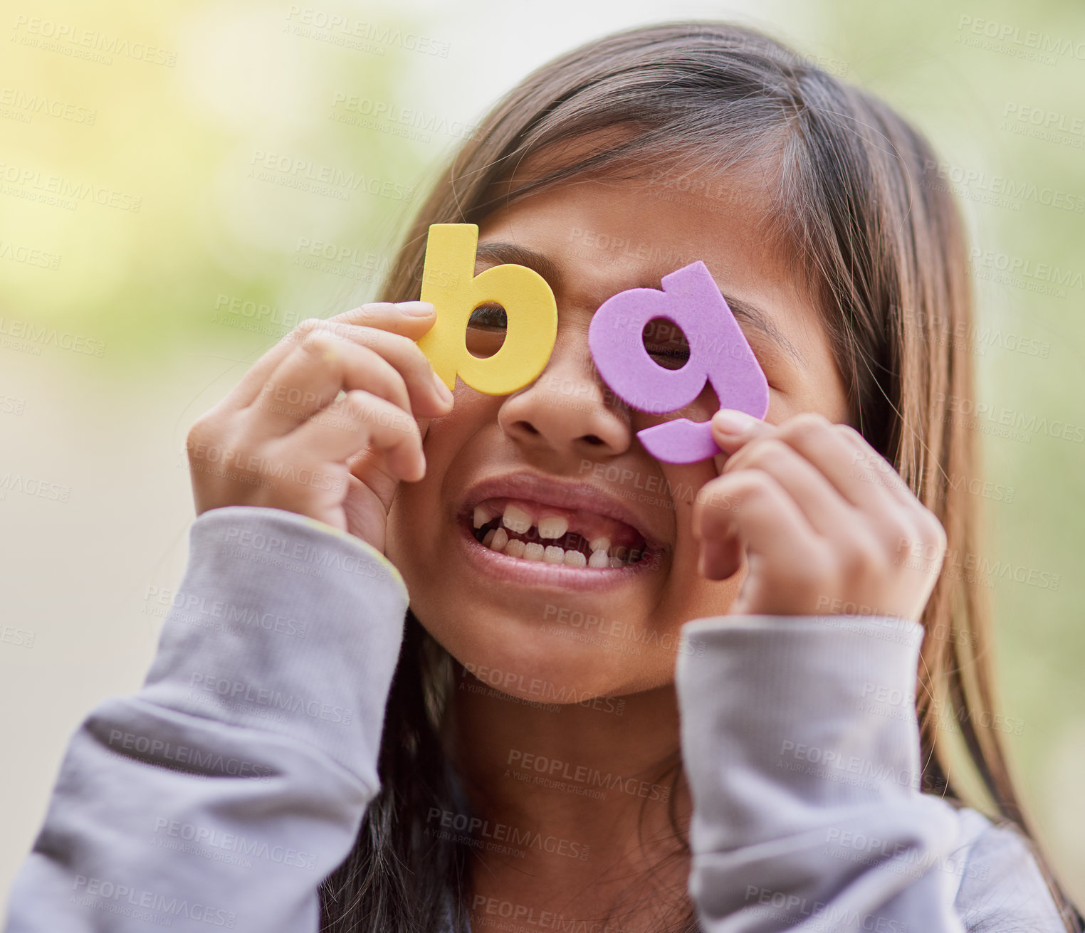 Buy stock photo Girl, alphabet and playful in learning to read as scholar in home schooling with letters for fun. Happy child, student and education in elementary with smile for development, growth and colorful abc