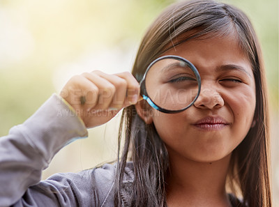 Buy stock photo Portrait of a little girl looking through a magnifying glass