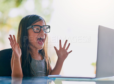 Buy stock photo Cropped shot of a little girl looking excited while using a laptop