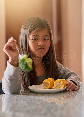 Buy stock photo Cropped shot of a little girl refusing to eat her broccoli