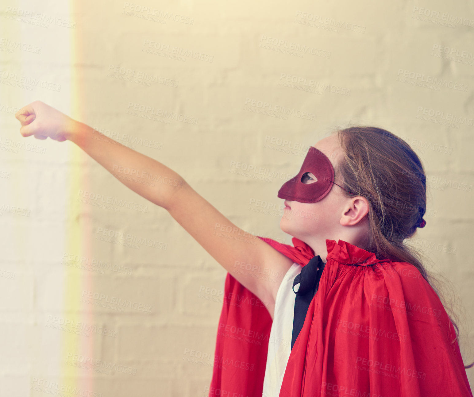 Buy stock photo Cropped shot of a little girl pretending to be a superhero