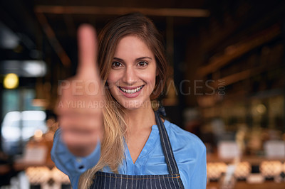 Buy stock photo Cropped portrait of an attractive young woman giving thumbs up while standing in her coffee shop