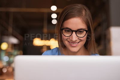Buy stock photo Cropped shot of an attractive young woman blogging in her local coffee shop