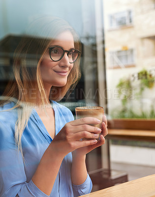 Buy stock photo Cropped shot of an attractive young woman enjoying the view while sitting in a coffee shop