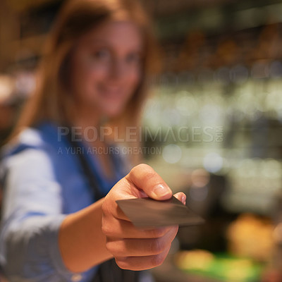 Buy stock photo Cropped portrait of a young woman giving your credit card back after processing payment