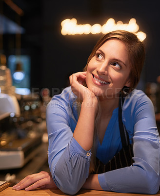 Buy stock photo Cropped shot of an attractive young woman looking thoughtful while working in her coffee shop