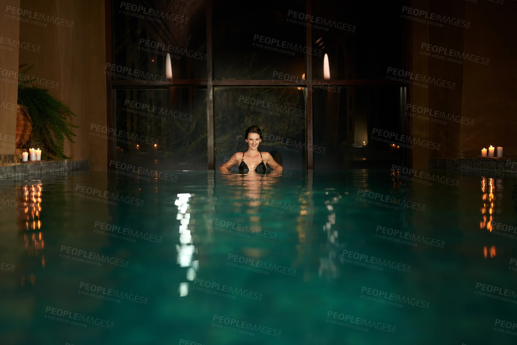 Buy stock photo Dark, pool and relax for woman in resort, calm and hotel or accommodation for holiday or vacation travel. Luxury, water and freedom for wellness and night for female person, spa and salon treatment