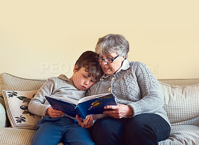 Buy stock photo Reading, grandmother and child on sofa for education, learning or knowledge development in living room. Story, senior woman and young boy with book for storytelling, relax or bonding together in home