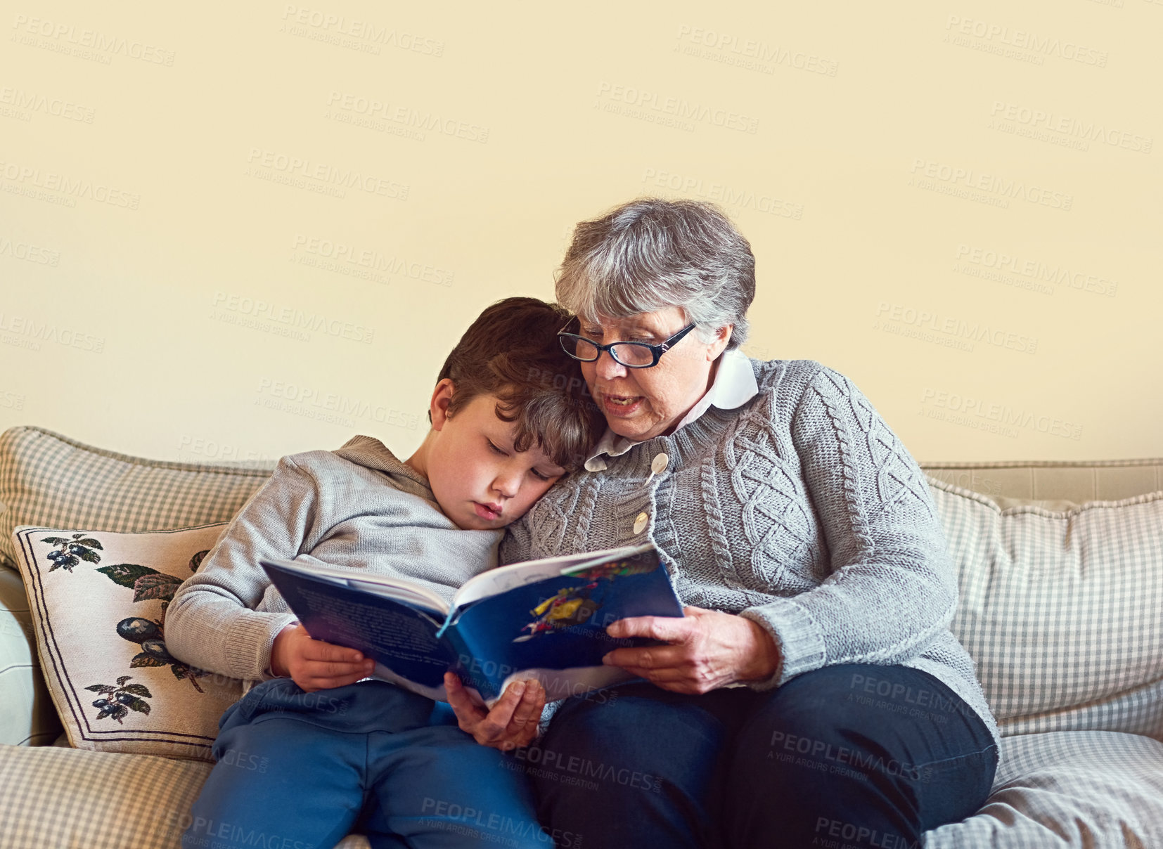 Buy stock photo Reading, grandmother and child on sofa for education, learning or knowledge development in living room. Story, senior woman and young boy with book for storytelling, relax or bonding together in home