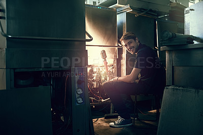 Buy stock photo Portrait, handyman and oven for repair, maintenance and problem solving or fixing in workshop. Male electrician, contractor and electronic appliance for inspection, testing or check cables as service