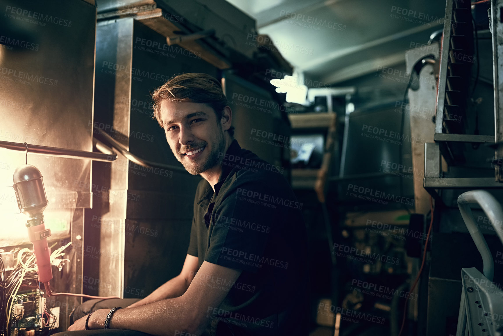 Buy stock photo Cropped portrait of a handsome young man making some repairs indoors