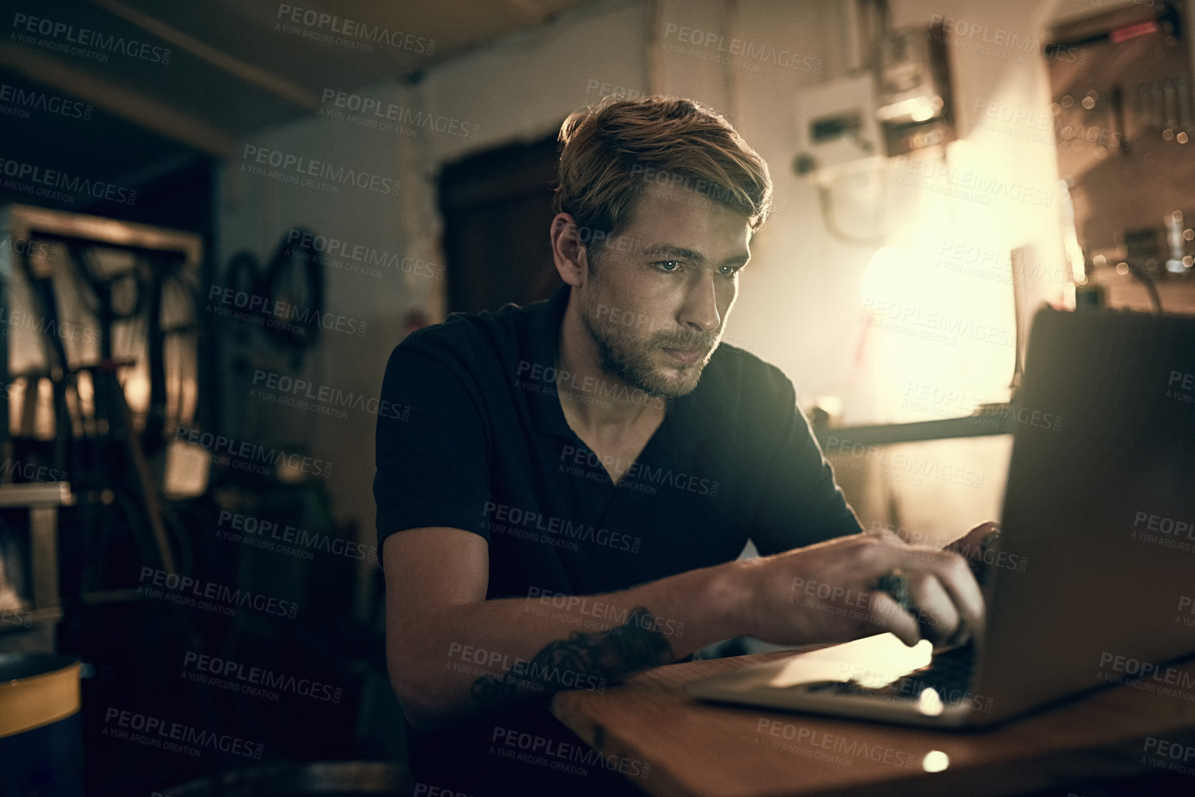 Buy stock photo Cropped shot of a handsome young man working late in his office