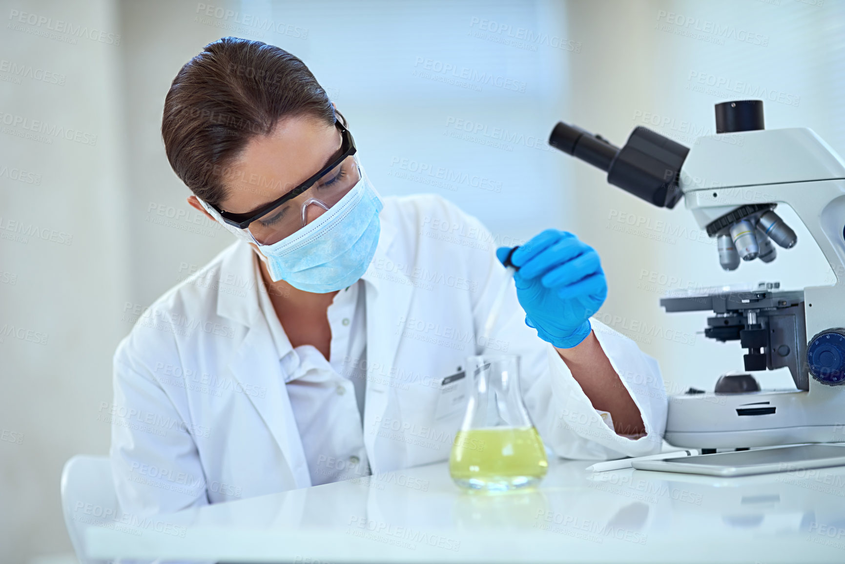 Buy stock photo Shot of a female scientist working alone in the lab