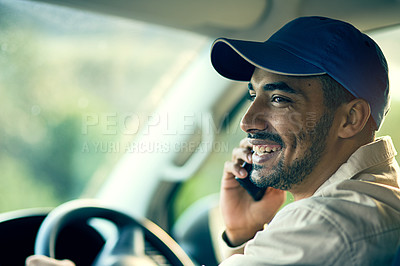 Buy stock photo Cropped shot of a delivery man talking on a cellphone while sitting in his van