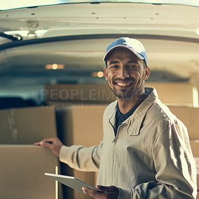 Buy stock photo Portrait of a delivery man using a digital tablet while checking the boxes in his van