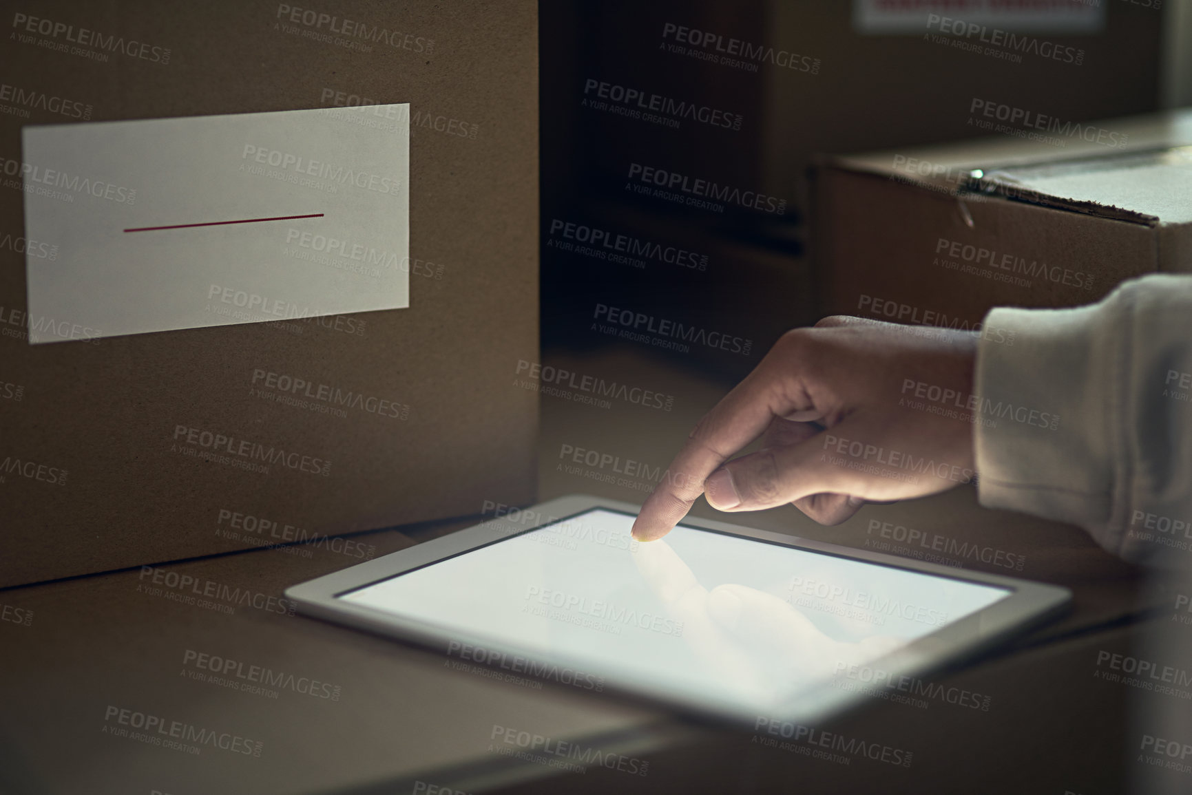 Buy stock photo Closeup shot of an unidentifiable delivery man using a digital tablet
