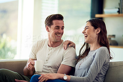 Buy stock photo Shot of a happy young couple relaxing together at home