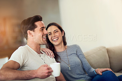 Buy stock photo Shot of a happy young couple relaxing together at home