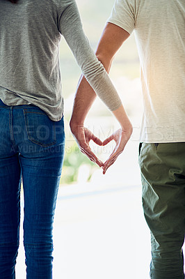 Buy stock photo Cropped shot of a couple making a hear gesture with their hands